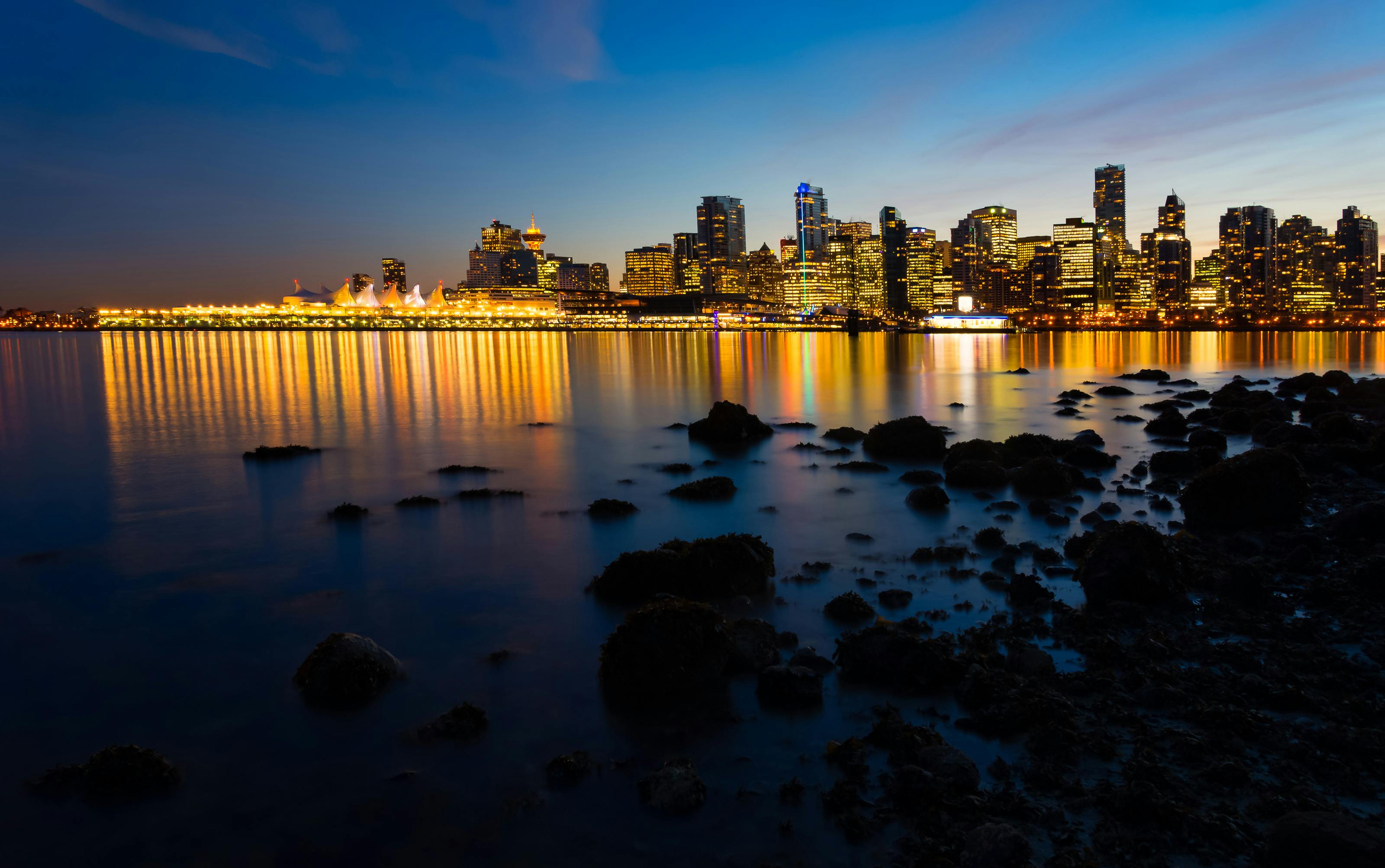 Vancouver city skyline showing building lights at dusk.